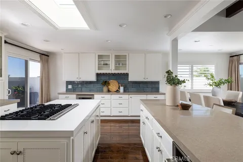 a kitchen with sink a stove and cabinets