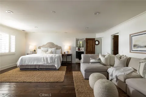 a bedroom with a bed couch and window