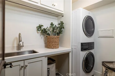 a utility room with sink dryer and washer