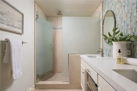 a bathroom with a sink a mirror and a shower
