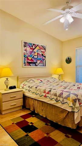 a bedroom with a bed and painting on the wall
