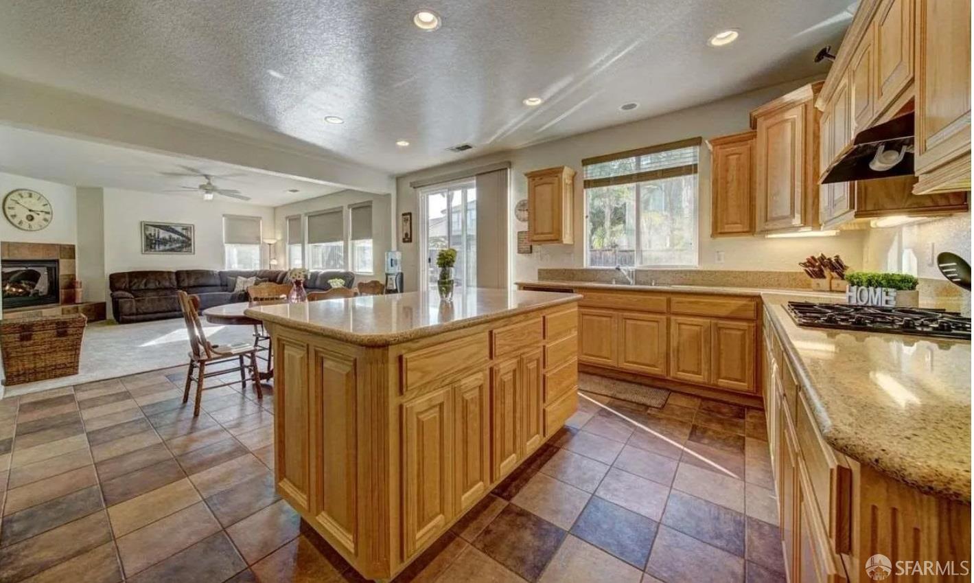 716 Seminole Court Discovery Bay, CA 94505 - Photo 21 of 21 a kitchen with stainless steel appliances granite countertop sink stove top oven and cabinets