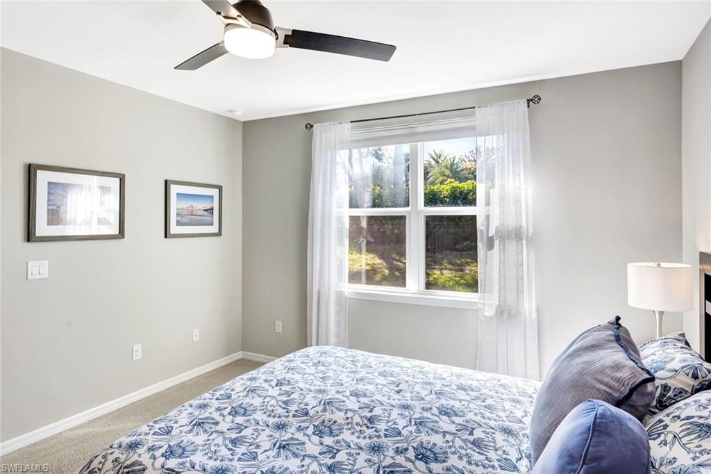 14863 Edgewater Circle Naples, FL 34114 - Photo 11 of 35 a bedroom with a bed and a window