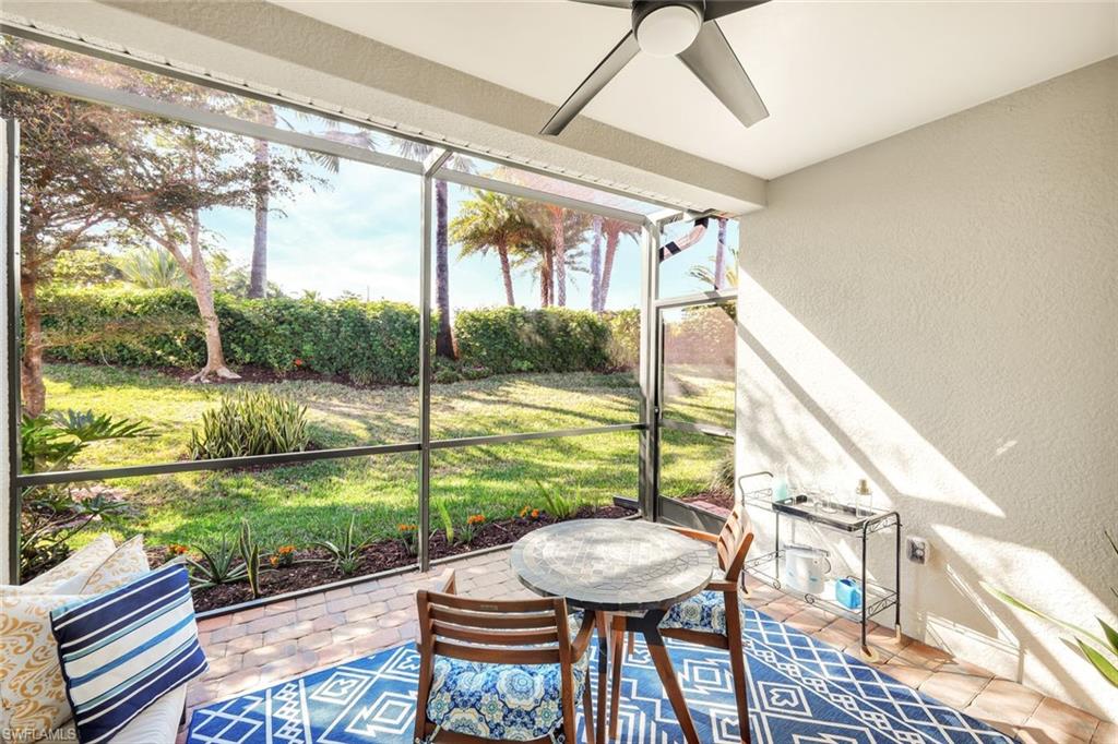 14863 Edgewater Circle Naples, FL 34114 - Photo 18 of 35 a view of a porch with furniture and wooden floor