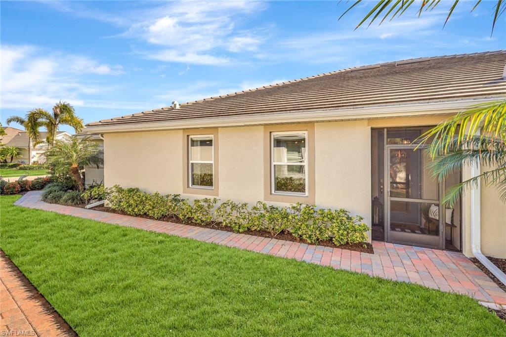 14863 Edgewater Circle Naples, FL 34114 - Photo 21 of 35 a front view of house with yard and green space