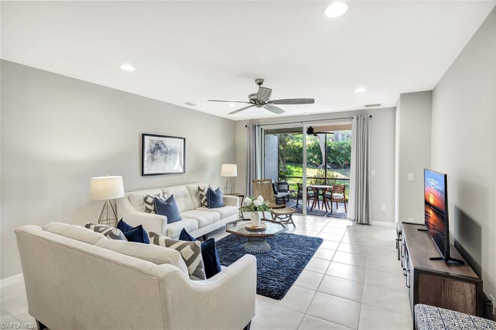 14863 Edgewater Circle Naples, FL 34114 - Photo 8 of 35 a living room with furniture tv and a flat screen tv