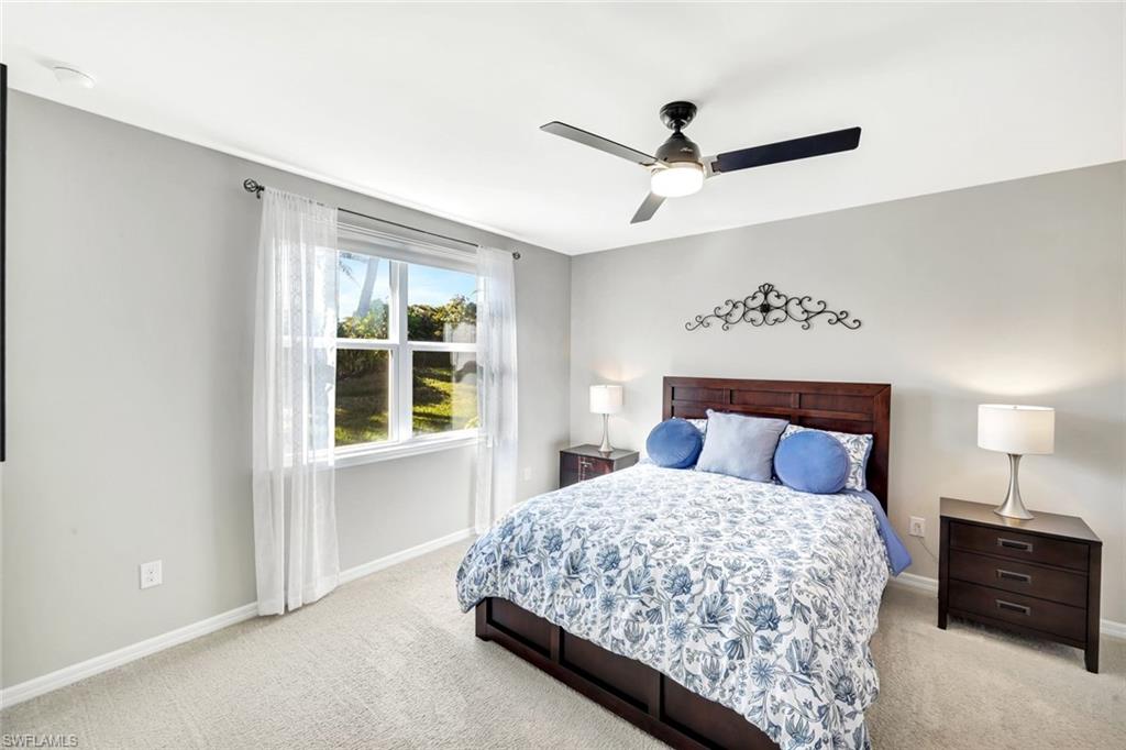 14863 Edgewater Circle Naples, FL 34114 - Photo 10 of 35 a bedroom with a large bed and a window