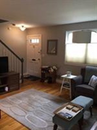 63 Linden Street, Unit 7 Wellesley, MA 02482 - Photo 4 of 11 a living room with furniture a window and a flat screen tv