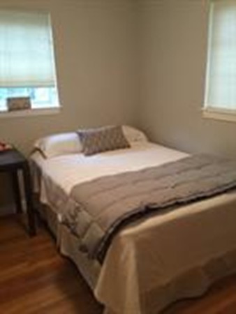 63 Linden Street, Unit 7 Wellesley, MA 02482 - Photo 9 of 11 a bed sitting in a bedroom next to a window