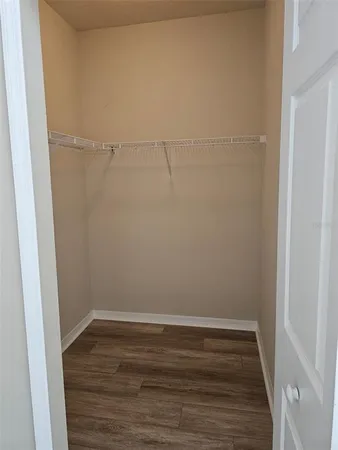 a view of a room with wooden floor