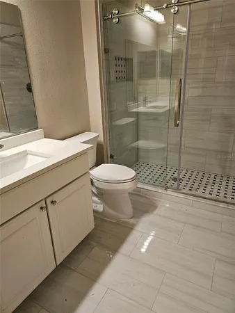 a bathroom with a toilet and a shower