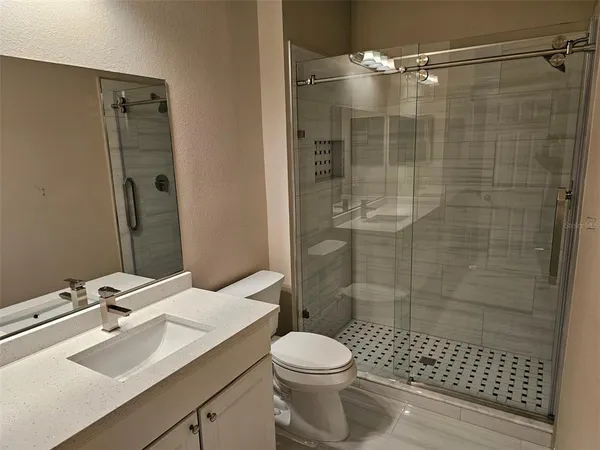 a bathroom with a sink toilet and shower