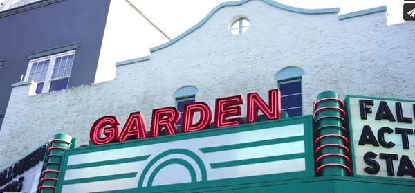 a group of people sitting outside of a kitchen