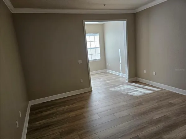 a view of wooden floor and windows in a room
