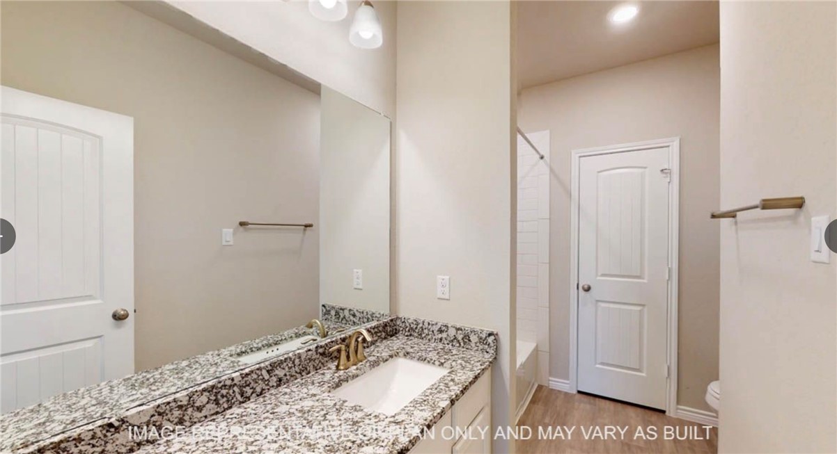 9805 Bridlewood Lane Waco, TX 76708 - Photo 25 of 35 a bathroom with a sink and a mirror