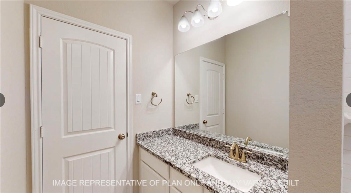 9805 Bridlewood Lane Waco, TX 76708 - Photo 26 of 35 a bathroom with a granite countertop sink and a mirror