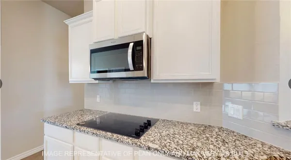 a kitchen with a stove and a microwave
