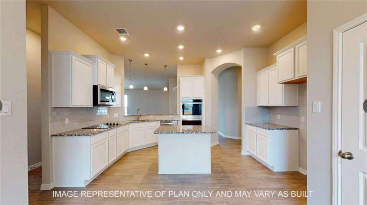 9805 Bridlewood Lane Waco, TX 76708 - Photo 5 of 35 a kitchen with stainless steel appliances granite countertop a sink and a refrigerator