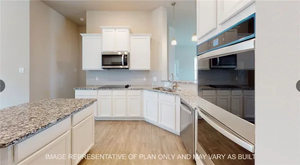 a kitchen with a sink and a microwave