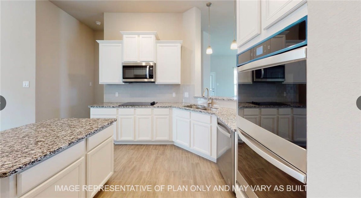 9805 Bridlewood Lane Waco, TX 76708 - Photo 6 of 35 a kitchen with a sink and a microwave