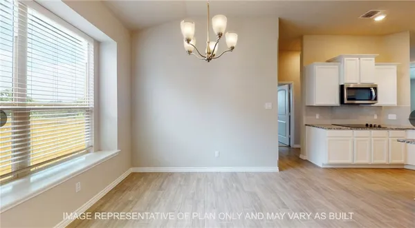 a view of a kitchen with granite countertop cabinets and a wooden floor