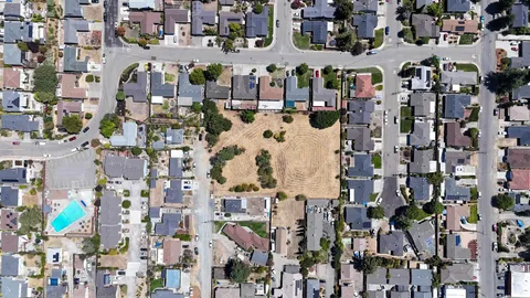 an aerial view of residential houses with outdoor space