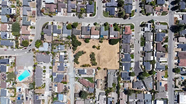 an aerial view of residential houses with outdoor space