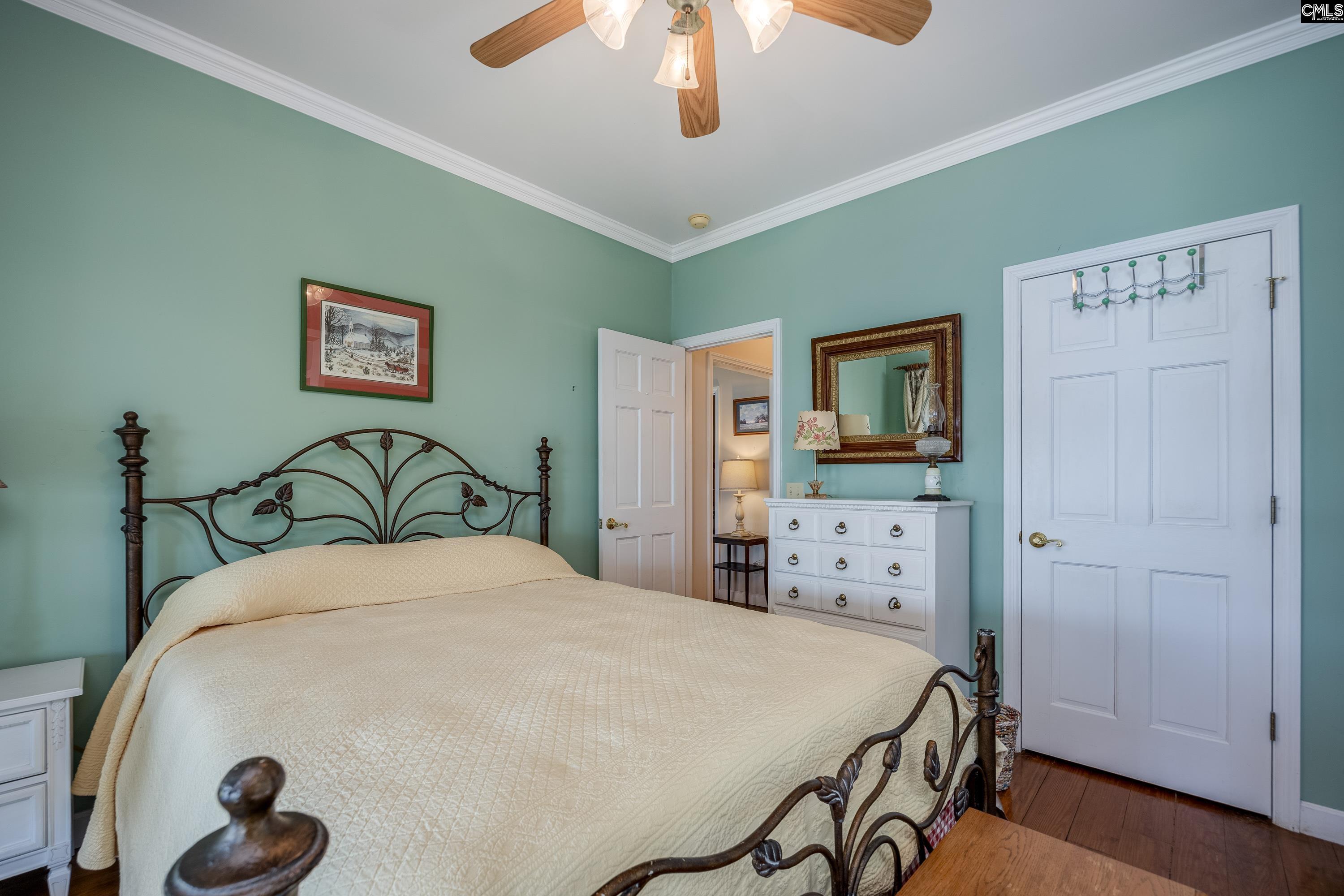 2577 Harbor View Road Camden, SC 29020 - Photo 31 of 42 a large bedroom with a bed and a chandelier