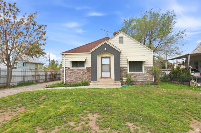676 South 500 West Provo, UT 84601 - Photo 2 of 29 View of front facade featuring stone siding, a chimney, and a shingled roof