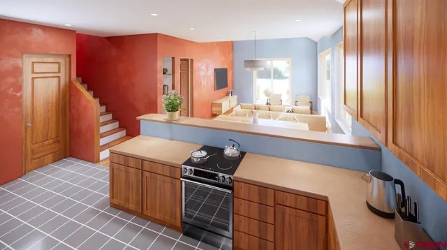 a kitchen that has a sink wooden cabinets and stainless steel appliances
