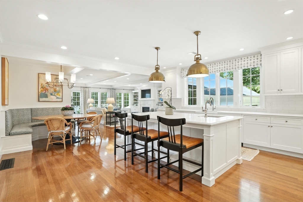 15 Winthrop Road Lexington, MA 02421 - Photo 11 of 39 a large dining hall with stainless steel appliances kitchen island granite countertop a table chairs and a living room