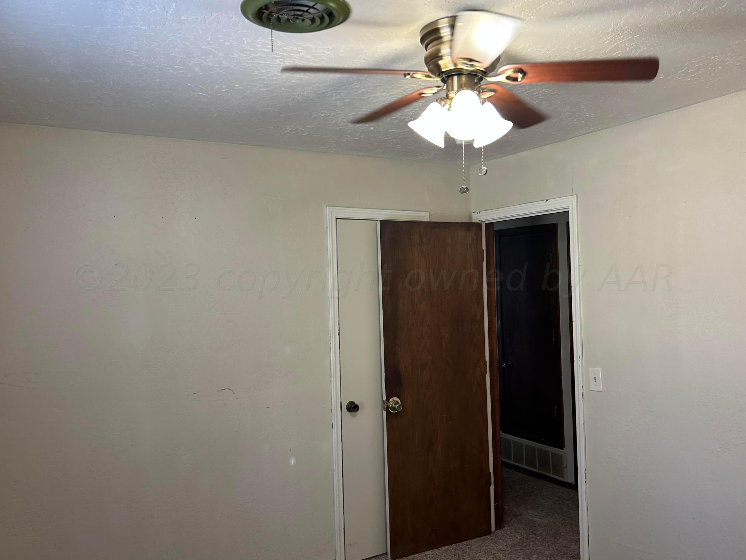 5321 Capulin Lane Amarillo, TX 79110 - Photo 13 of 16 a bathroom with a light fixture and a chandelier
