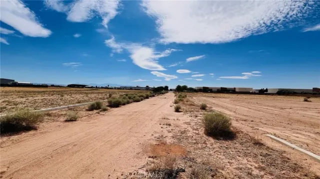a view of a lake with beach in back