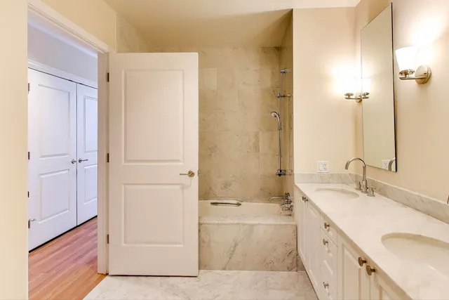 a bathroom with a sink a mirror and a bathtub