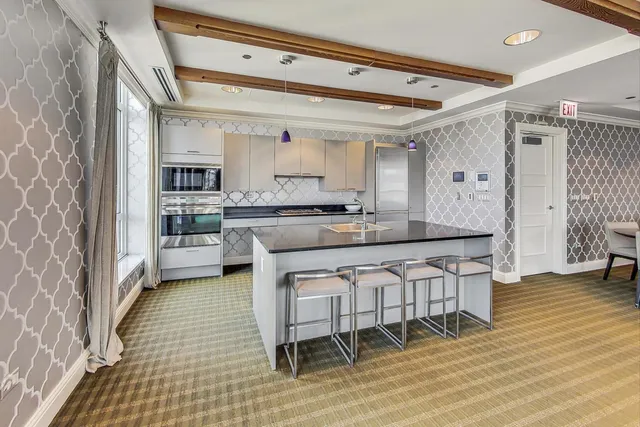 a kitchen with stainless steel appliances a sink and cabinets