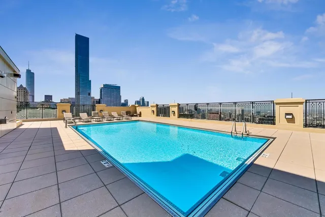 an outdoor space with pool and furniture