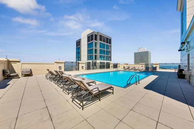 a view of a swimming pool with a lounge chairs