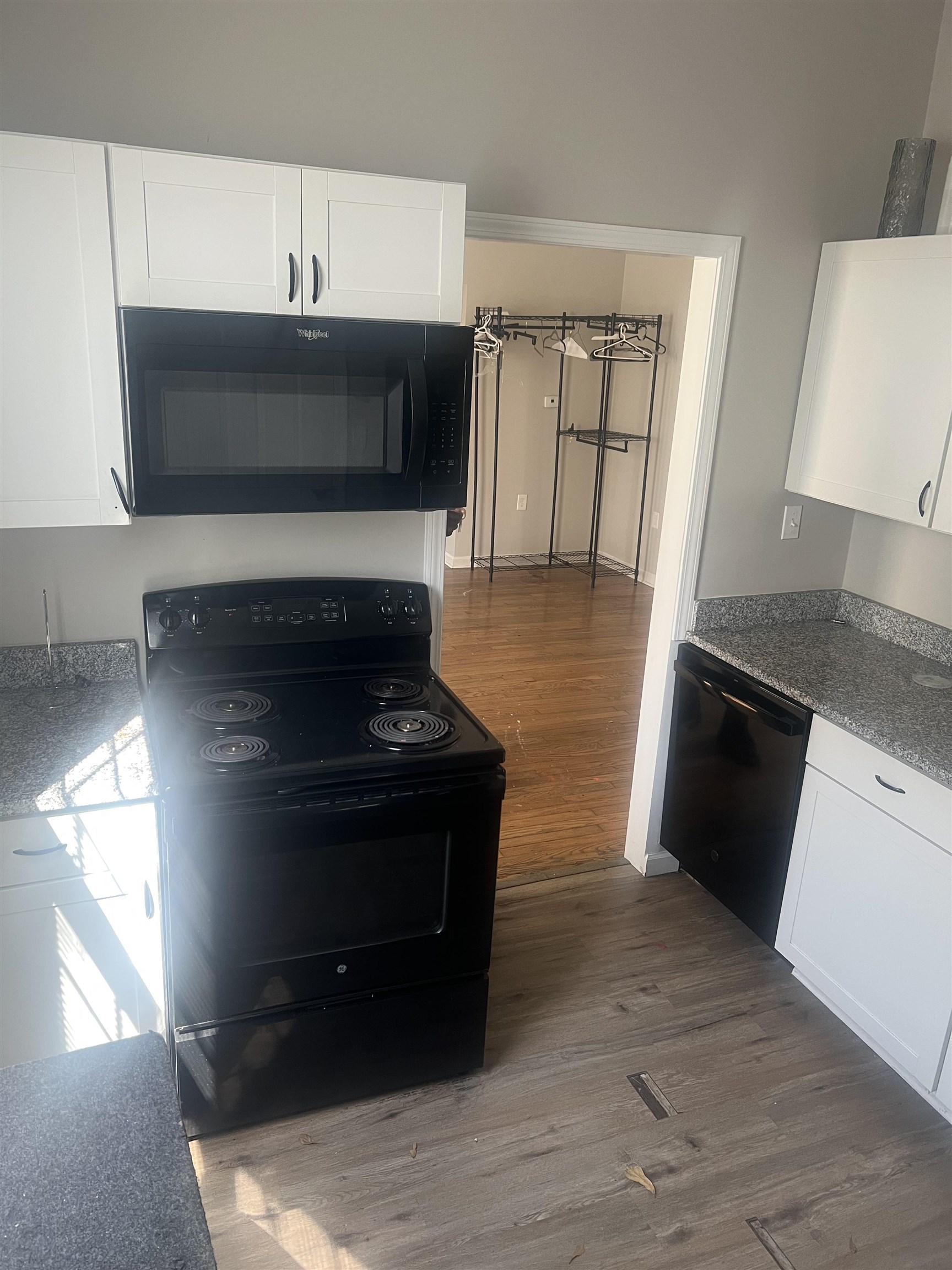1353 Harbert Avenue Memphis, TN 38104 - Photo 11 of 18 a kitchen with granite countertop a stove and a refrigerator