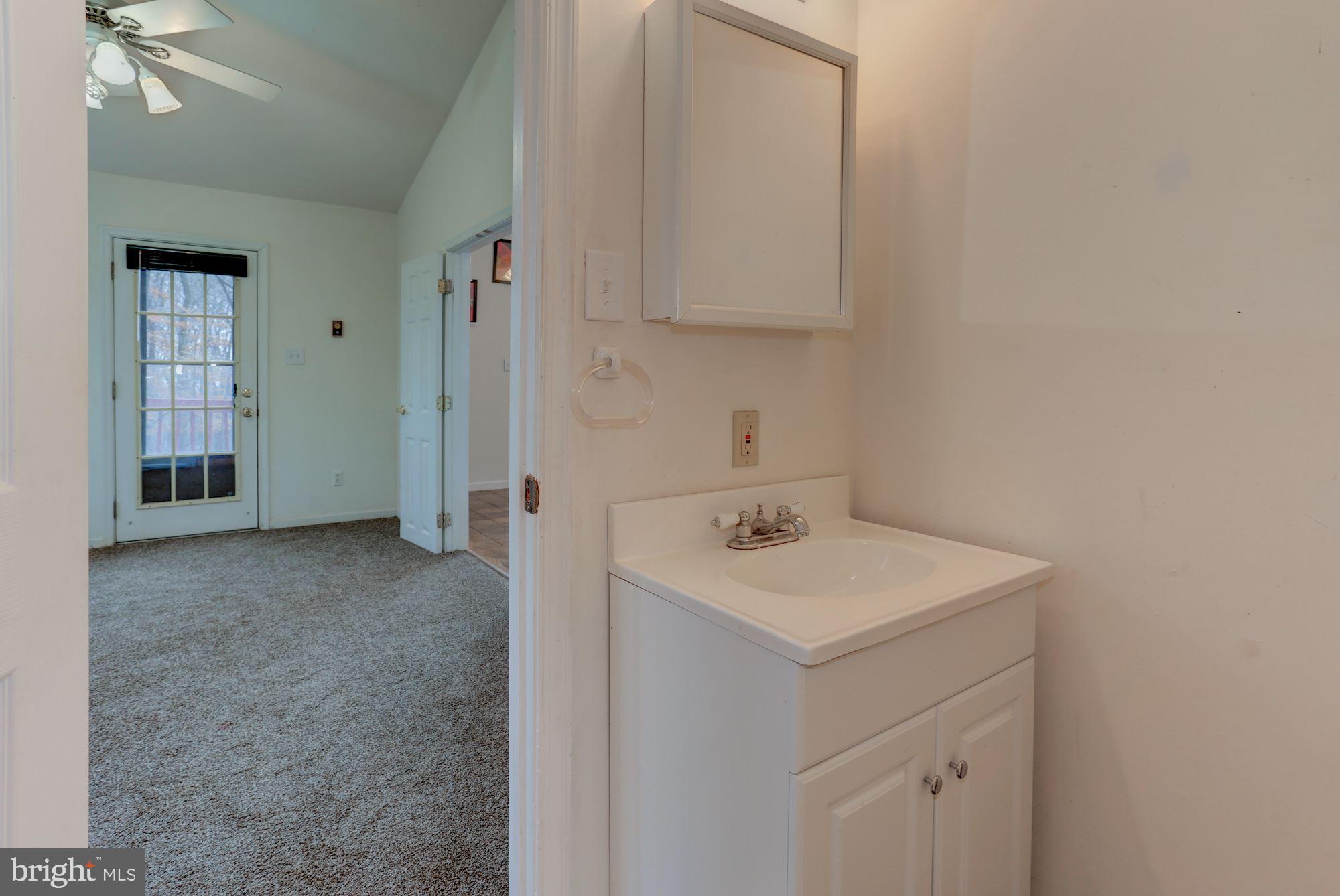 103 Club House Road Front Royal, VA 22630 - Photo 12 of 30 a bathroom with a sink a vanity and a mirror