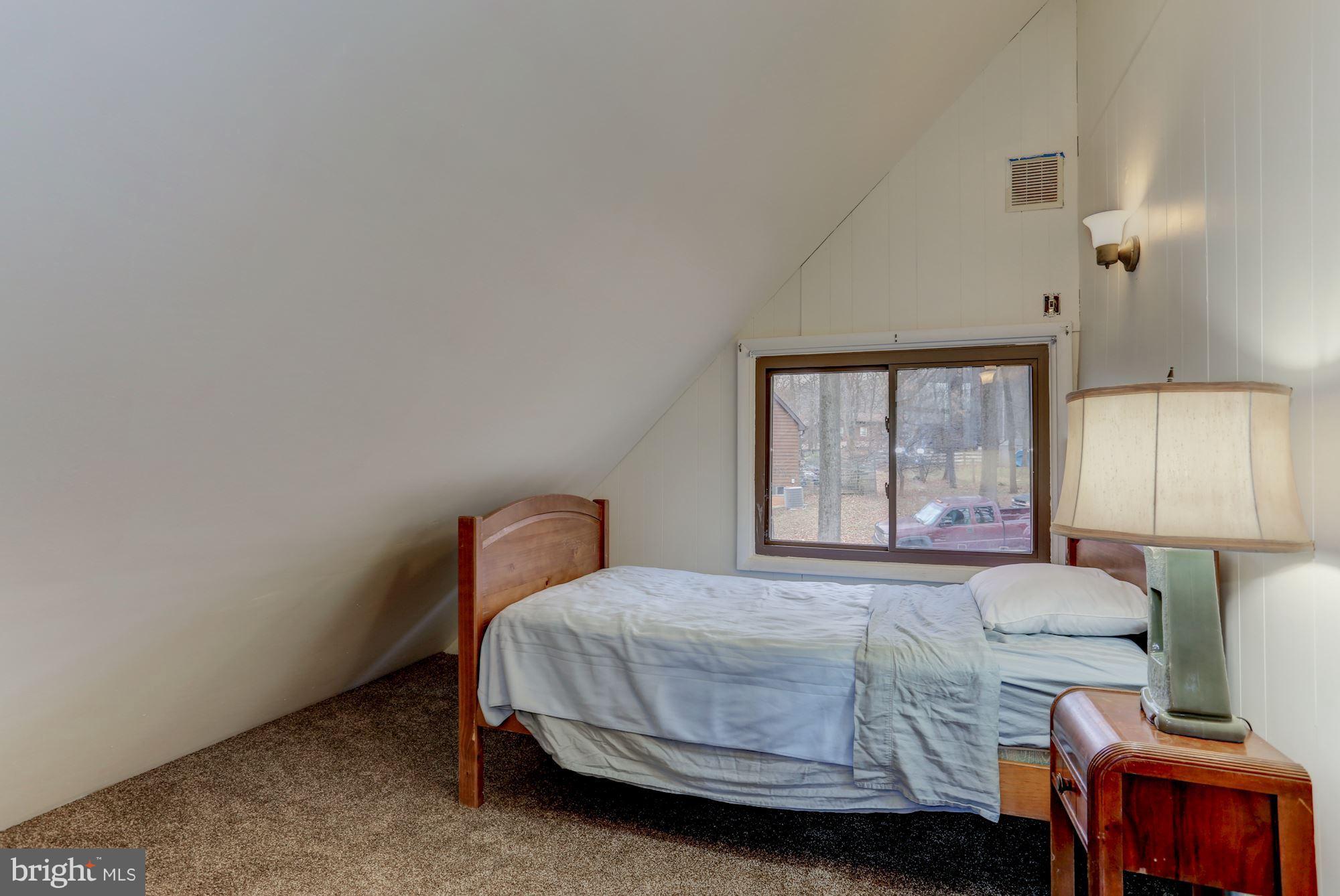 103 Club House Road Front Royal, VA 22630 - Photo 18 of 30 a bedroom with a bed and a window