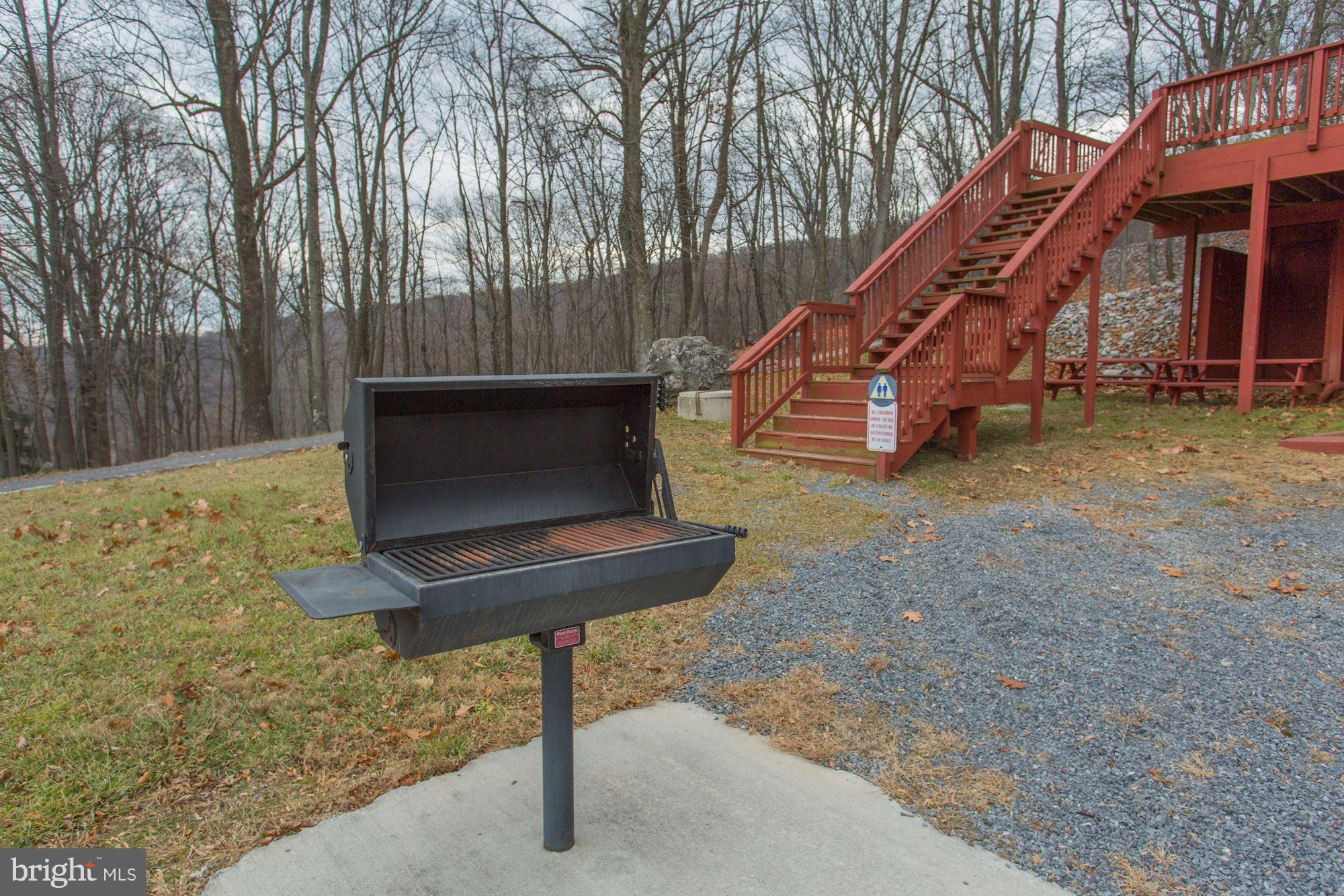 103 Club House Road Front Royal, VA 22630 - Photo 27 of 30 a backyard of a house with sofas table and chairs