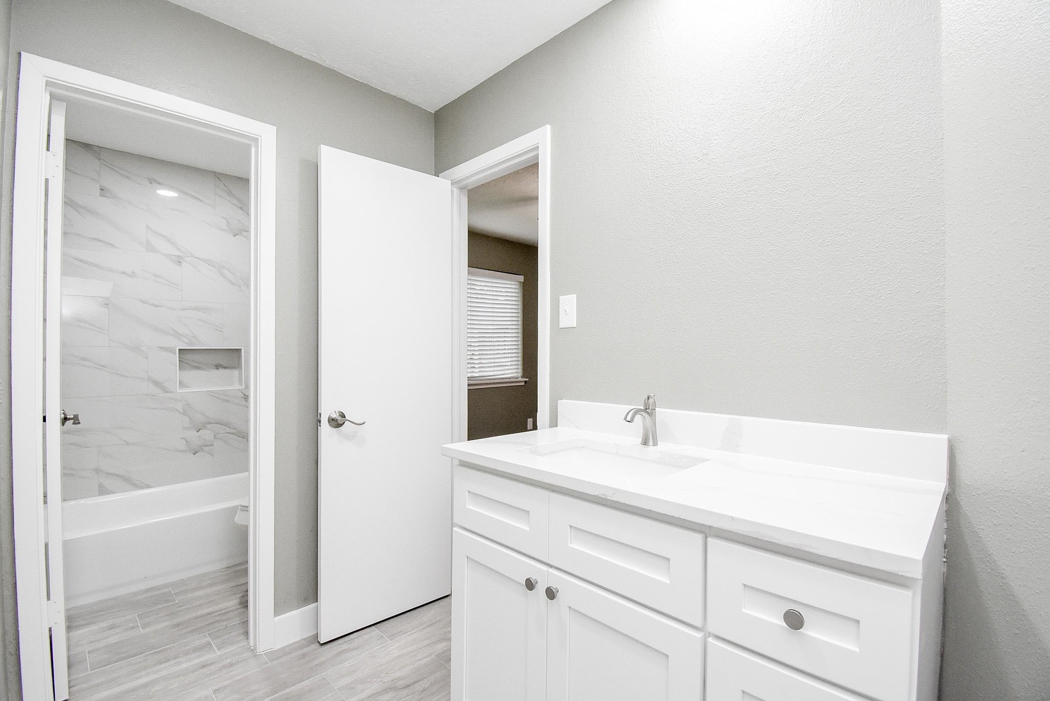 17330 Modbury Drive Spring, TX 77379 - Photo 17 of 30 Bright and modern bathroom featuring sleek white cabinetry, a spacious vanity, and elegant wall to wall tile in the shower.