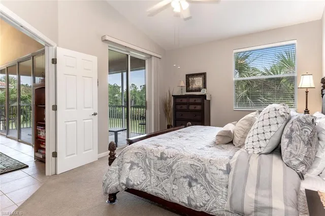 a bedroom with a bed and a dresser next to a window