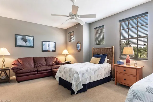 a bedroom with a bed couch and window