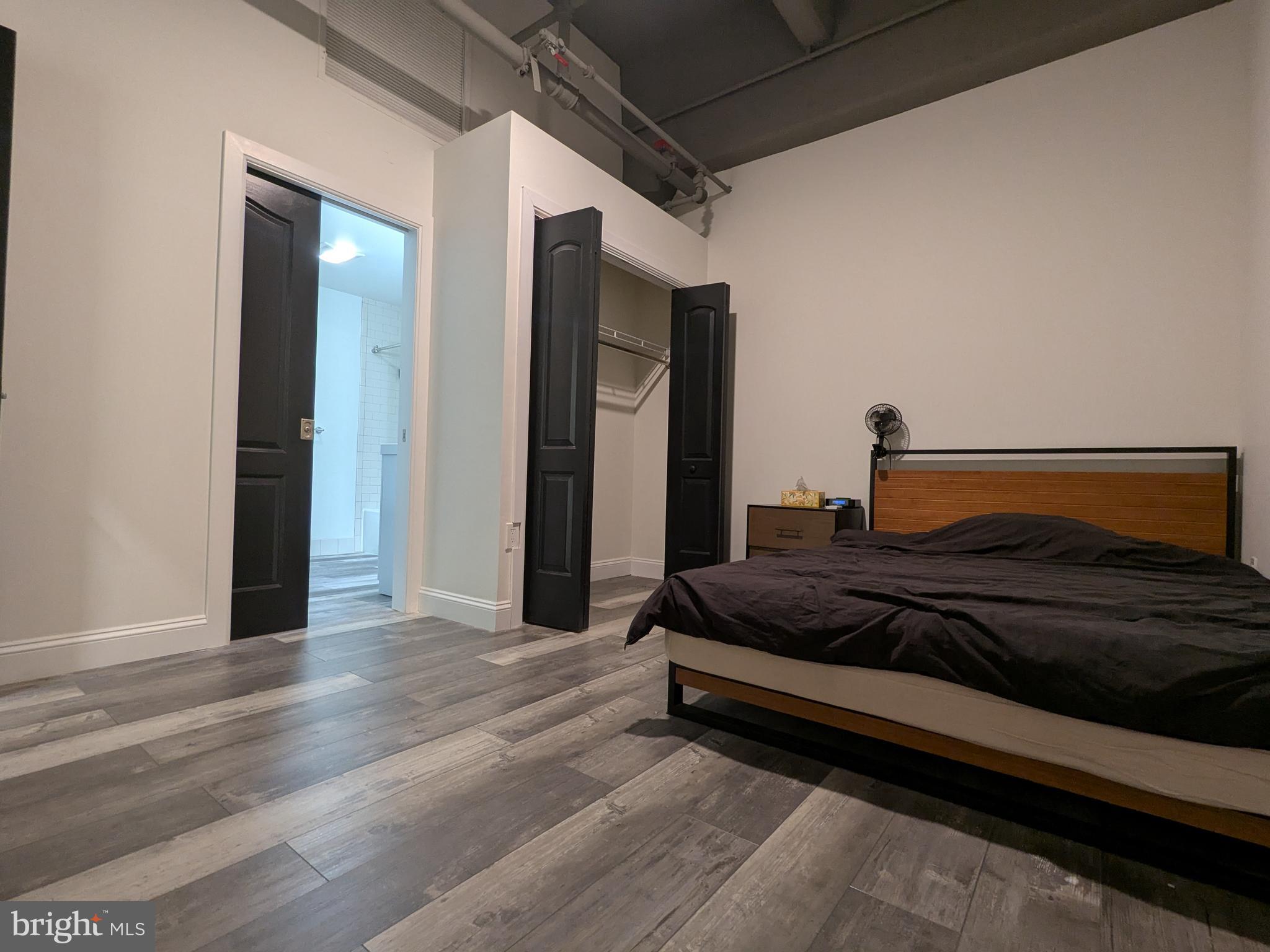 511 North Broad Street, Unit 204 Philadelphia, PA 19123 - Photo 12 of 47 a bedroom with a bed and a mirror