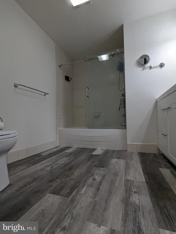 a view of a room with wooden floor and a sink