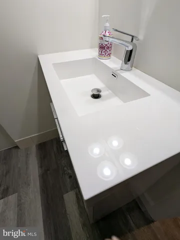 a close view of kitchen sink with granite countertop