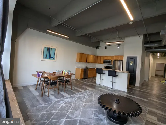 a view of kitchen with stainless steel appliances granite countertop a sink and a stove