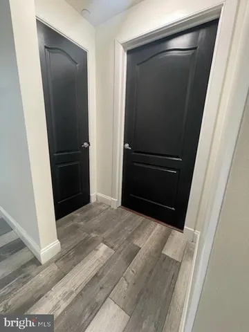 a room with wooden cabinets and stainless steel appliances