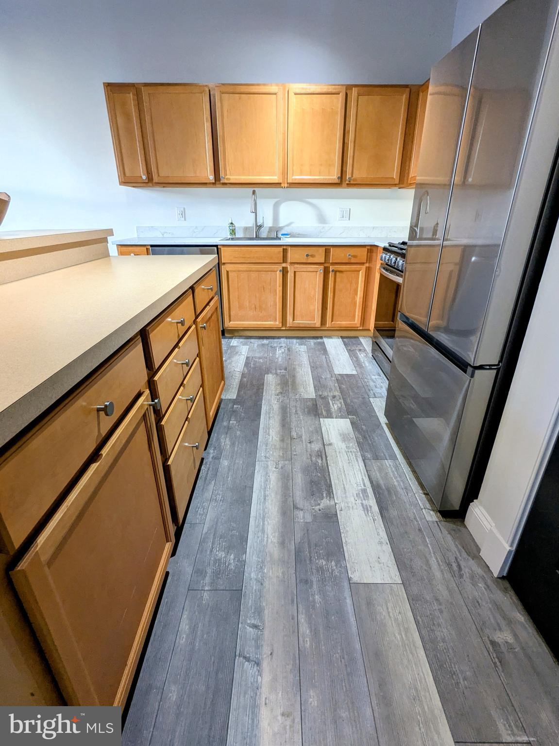 511 North Broad Street, Unit 204 Philadelphia, PA 19123 - Photo 7 of 47 a view of a kitchen with a sink and wooden floor